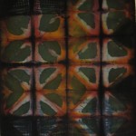 Close image showing detail of clamp and soy wax resist dye pattern on fabric by Maureen Jakubson